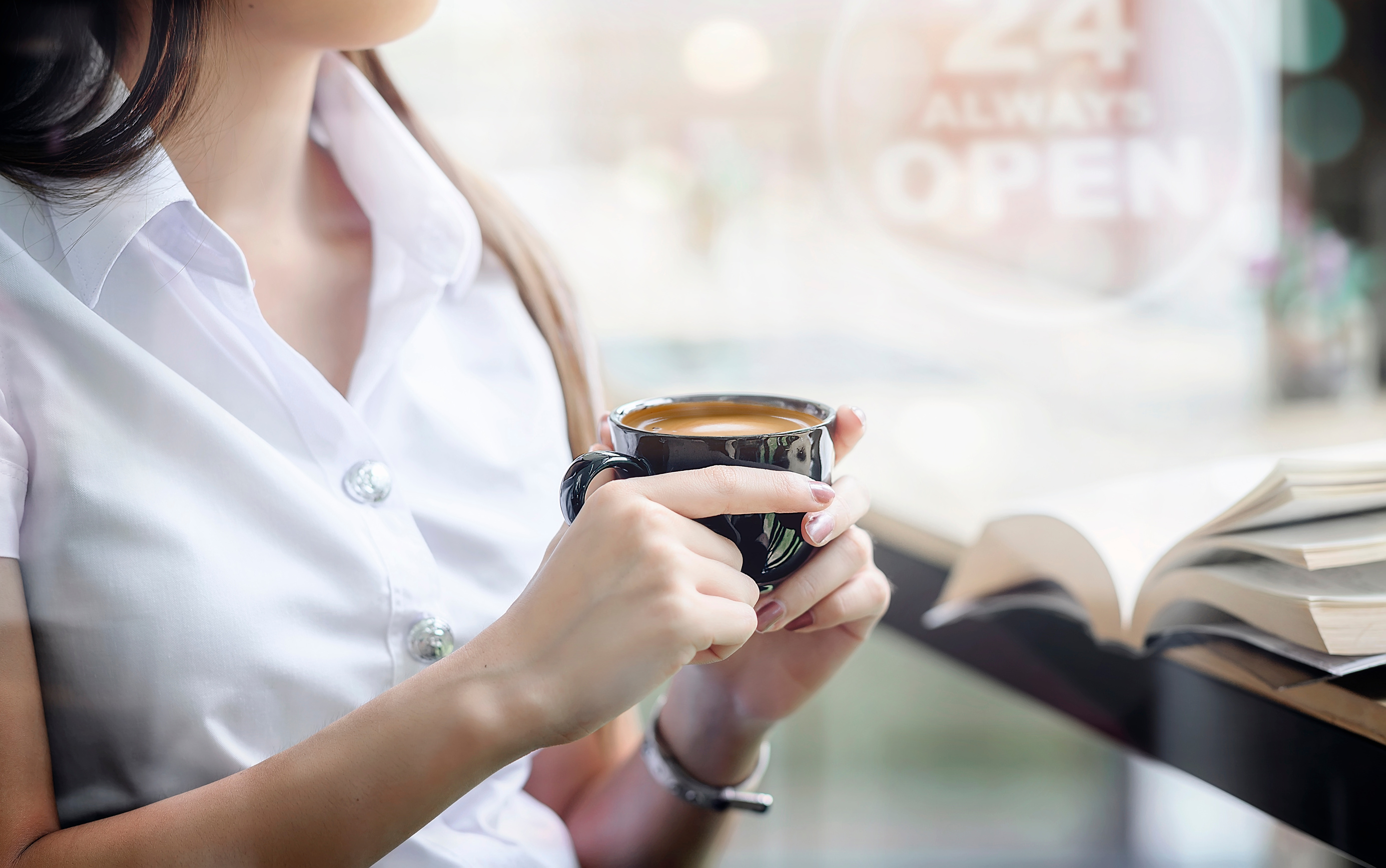 Female Hand Holding Cup of Coffee 